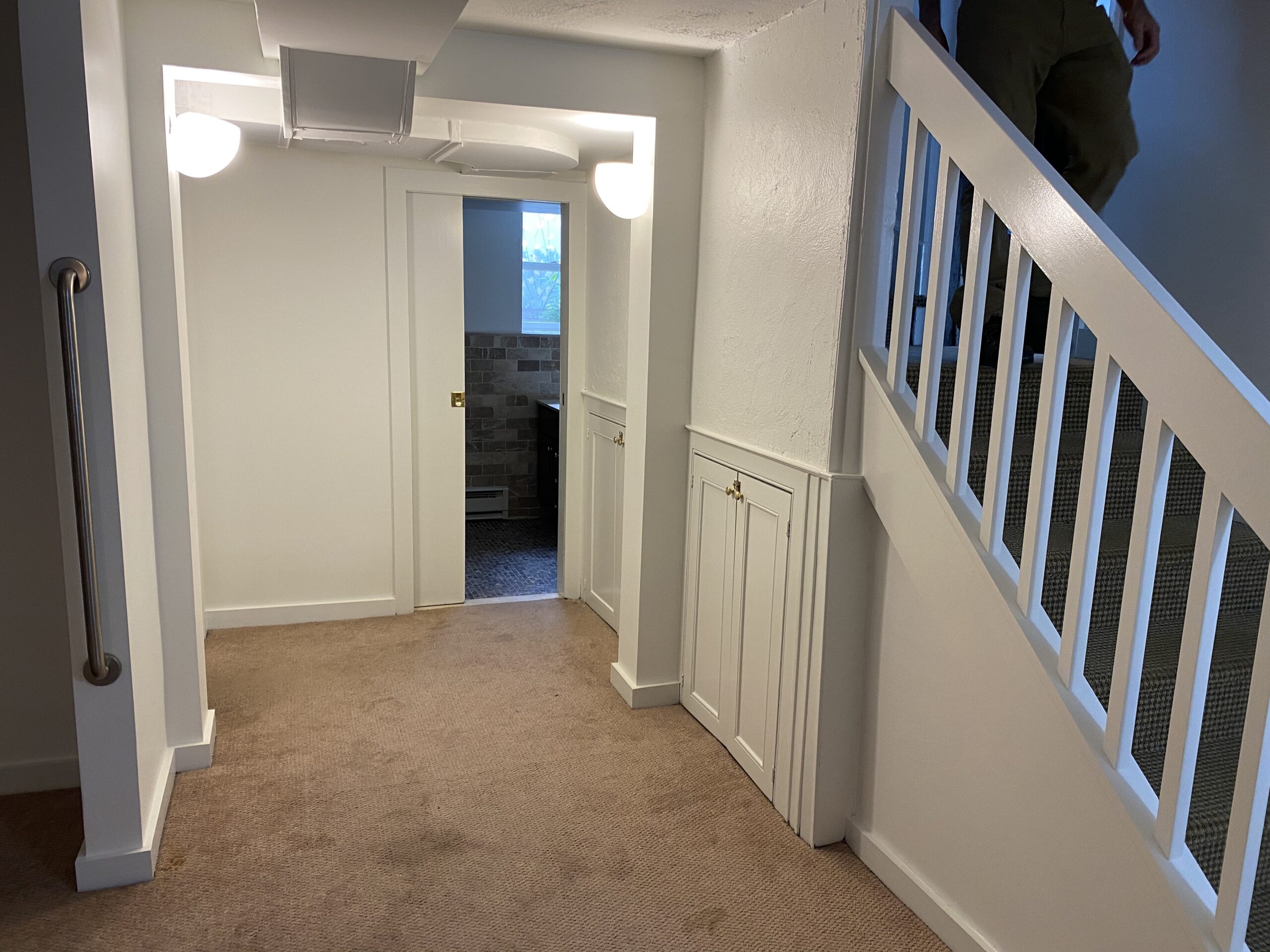 Freshly painted interior stairwell and hallway with white walls and trim