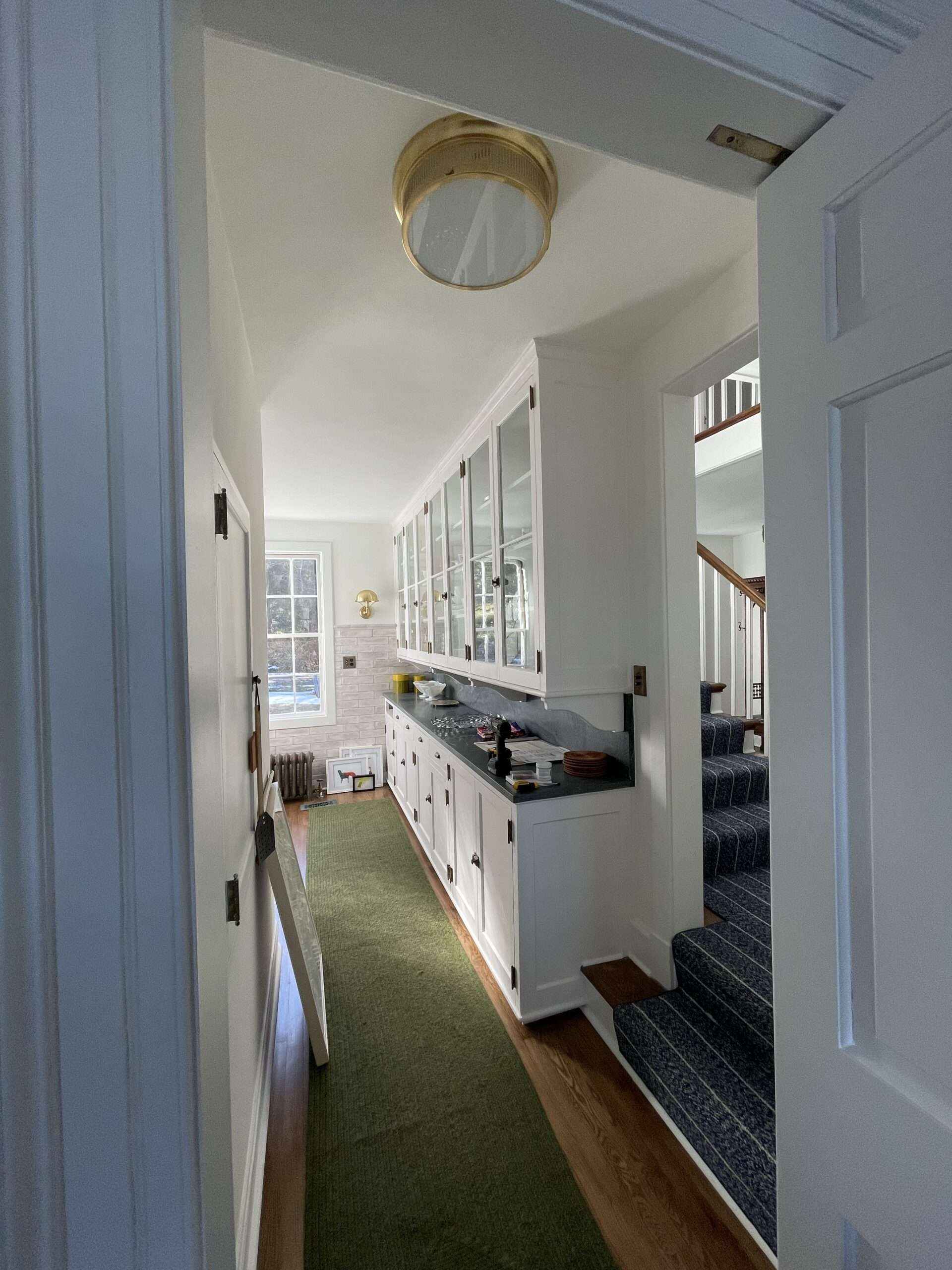 Freshly painted white built-in cabinetry and trim in a Westchester home hallway
